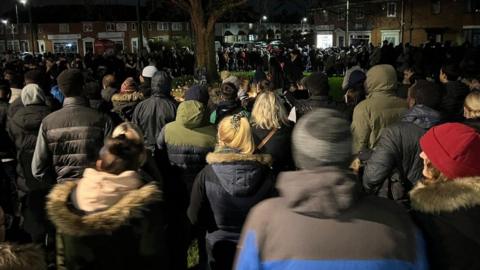 People attending a vigil