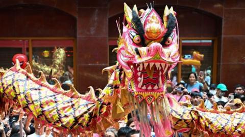 Dragon dancers perform for the crowd in Manila