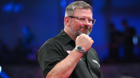 James Wade celebrates