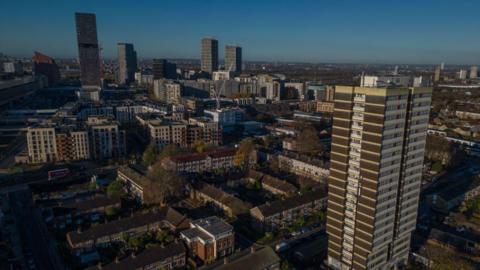 Aerial view of homes and a high-rise block in Stratford