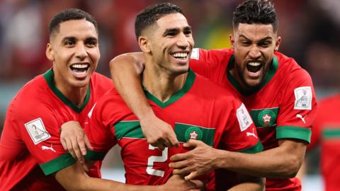 Achraf Hakimi of Morocco (centre) celebrates after scoring the winning penalty against Spain