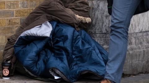 A homeless person sleeping on the street