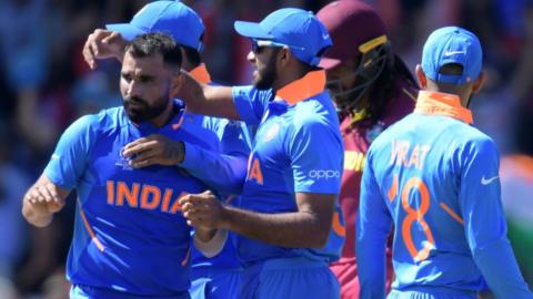 India's Mohammed Shami (L) celebrates with teammates