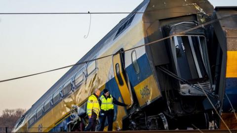 The authorities inspect a carriage of a derailed passenger train in the Netherlands