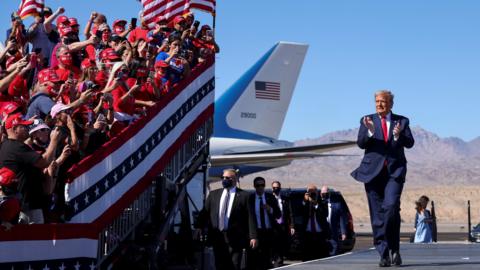 U.S. President Donald Trump applauds as he arrives for a campaign rally at Laughlin/Bullhead International Airport in Bullhead City, Arizona, U.S., October 28, 2020