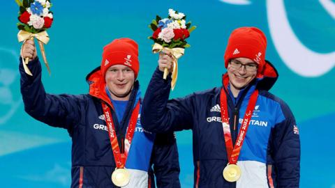 Neil Simpson and brother Andrew receive their medals