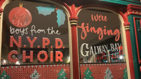 Pub windows with Fairytale of New York lyrics painted on them