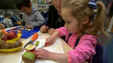 Children chop up fruit with knives and use an oven hob