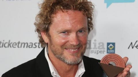 Craig McLachlan with an award in 2014