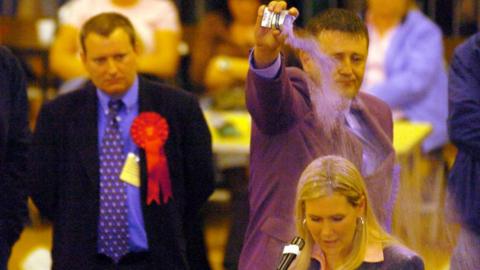 2004 Hartlepool by-election Liberal Democrat candidate Jody Dunn is covered with purple power by Fathers4Justice candidate Paul Watson