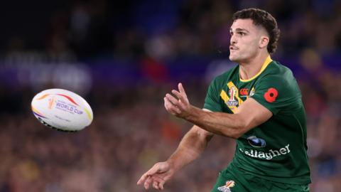 Nathan Cleary passes the ball to the left of frame while playing for Australia at the Rugby League World Cup in 2022