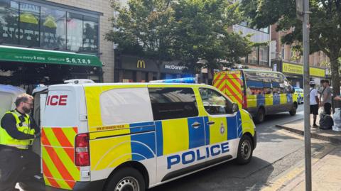 Two police vans parked outside of a McDonalds 