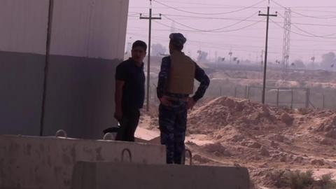 Two men stand guard in Kirkuk