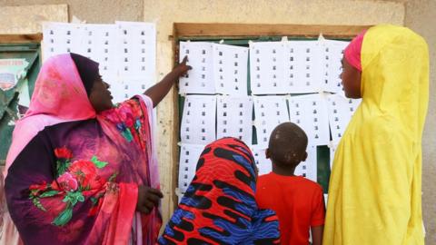People check voting lists during Nigeria"s presidential election