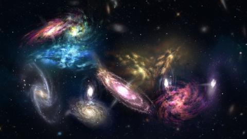 Spiral galaxies of blue, green, pink, gold, purple and white all poised to merge together