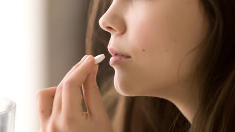 girl taking a tablet