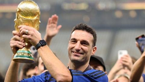 Argentina manager Lionel Scaloni lifts the World Cup trophy following his team winning last year's tournament