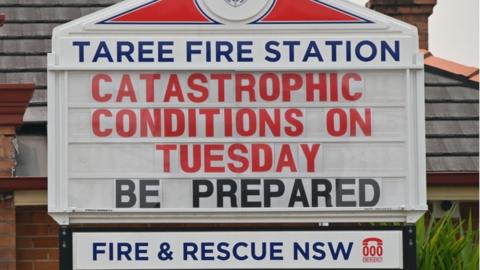 A sign warning people to be prepared for catastrophic fire conditions in Taree, NSW