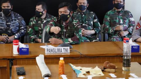 Indonesian naval officers with debris believed to be from the missing Indonesian sub - Bali, 24 April