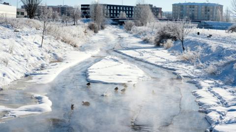 A view of the frozen Chico river in Avila, Spain, 12 January 2021