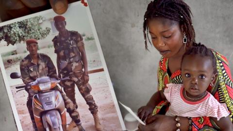 Malian soldiers and a mother and child