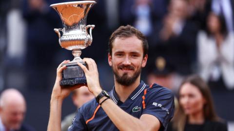 Daniil Medvedev poses with the Italian Open trophy after beating Holger Rune