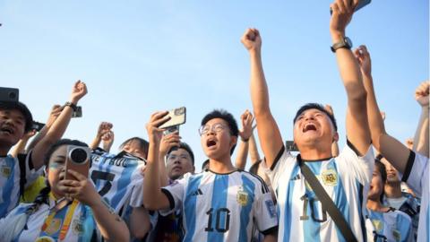 Fans in Messi jerseys at the Workers Stadium