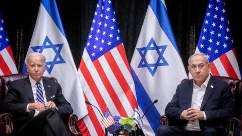 A photo of US president Joe Biden seated next to Israeli prime minister Benjamin Netanyahu