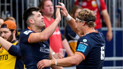 Edinburgh's Blair Kinghorn celebrates after scoring a try with Jamie Ritchie