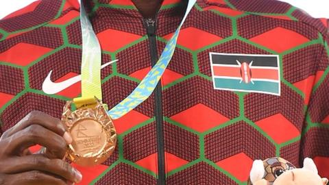 Anonymous Kenyan winner holds up medal