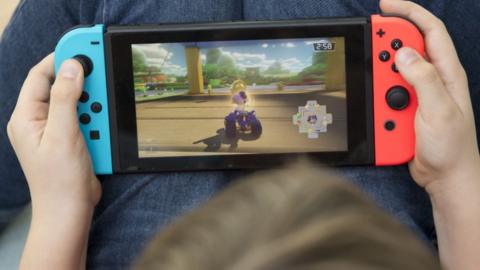 A boy plays the Nintendo Switch