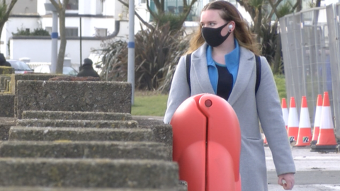 Woman walking along Douglas promenade