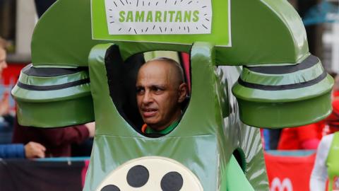 Dave Lock runs the London Marathon in his green telephone costume for Samaritans