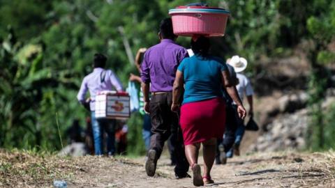 People walk after having crossed illegally the Suchiate river from El Carmen in Guatemala to Talisman in Chiapas State, Mexico