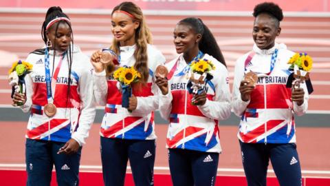 Asha Philip, Imani-Lara Lansiquot, Dina Asher-Smith and Daryll Neita of Great Britain with their bronze medals on the podium after the 4 x 100m relay at the Tokyo 2020 Olympic Games