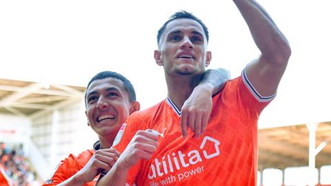 Jerry Yates celebrates giving Blackpool an early lead against Wigan Athletic