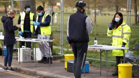 People take coronavirus tests on Clapham Common in London