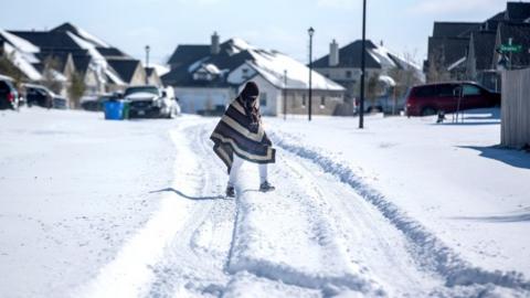 A Texan wearing a poncho in the snow