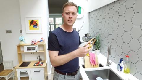 Author stands at sink