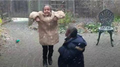 children dancing in the snow.