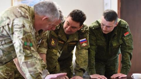 British Army officers briefing their Russian and Belarus counterparts