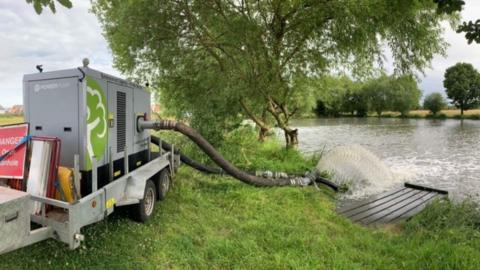 A machine adds oxygen to the impacted stretch of river