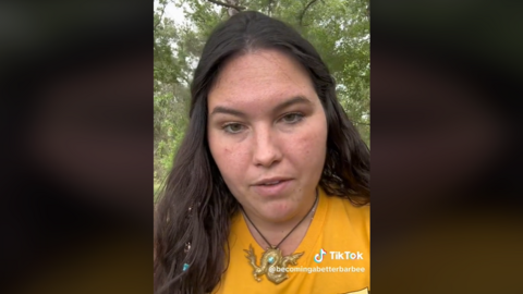 A screengrab shows Jenna Barbee in the video she posted to TikTok. She has long dark hair and is wearing a yellow t-shirt.