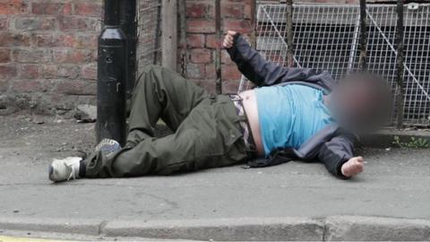 Man lay sprawled on street in Manchester