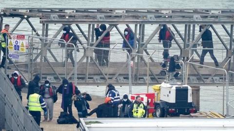 A group of people thought to be migrants are brought in to Dover, Kent, onboard a Border Force vessel following a small boat incident in the Channel