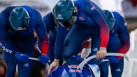 Brad Hall and his crew jump into their bobsleigh