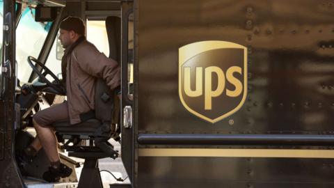 A United Parcel Service (UPS) driver sits in his delivery truck on January 31, 2023 in San Francisco, California.