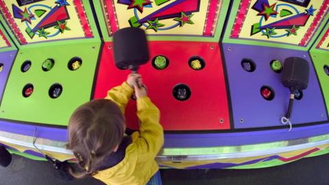 young girl playing whack-a-mole