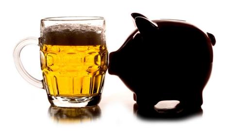 Pint of beer and piggy bank