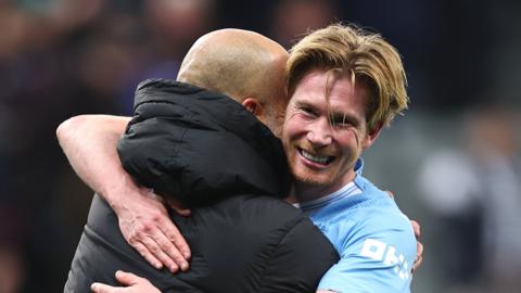 Manchester City's Kevin de Bruyne celebrates beating Newcastle in the Premier League with manager Pep Guardiola